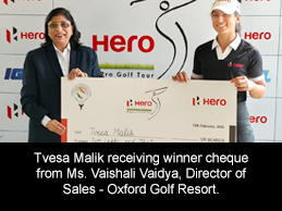 Tvesa Malik receiving winner cheque from Ms. Vaishali Vaidya, Director of Sales - Oxford Golf Resort.