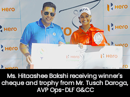 Ms. Hitaashee Bakshi receiving winner's cheque and trophy from Mr. Tusch Daroga, AVP Ops-DLF G&CC